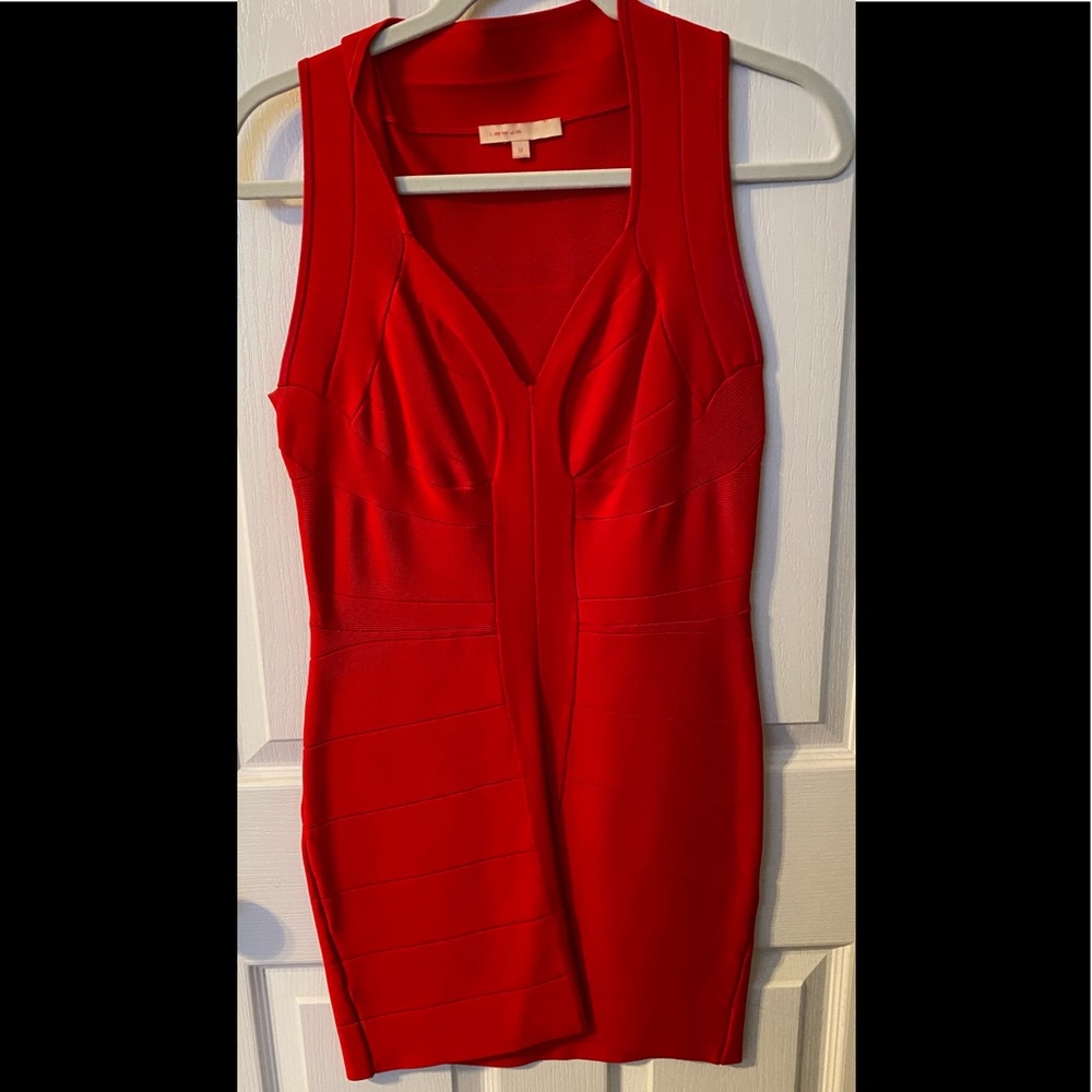 Red sleeveless bandage dress.